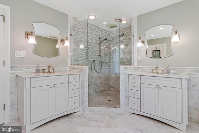 8412 Riverside Rd, Alexandria, VA 22308 - full bathroom featuring tile walls, a stall shower, marble look tiles, two vanities, and wainscoting
