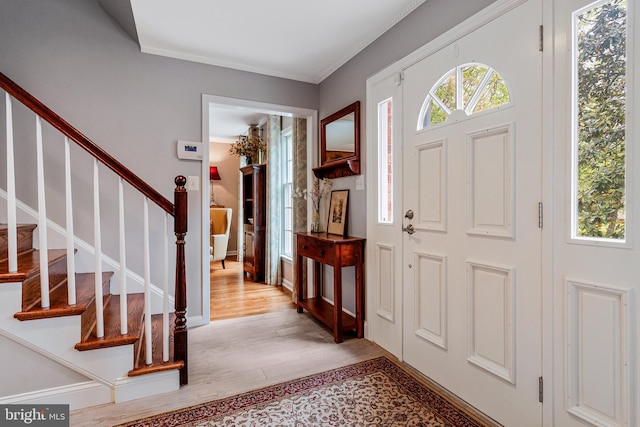 8412 Riverside Rd, Alexandria, VA 22308 - foyer entrance featuring light wood finished floors, stairs, and ornamental molding