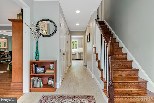 8412 Riverside Rd, Alexandria, VA 22308 - hall featuring light wood-type flooring, stairs, baseboards, ornamental molding, and recessed lighting