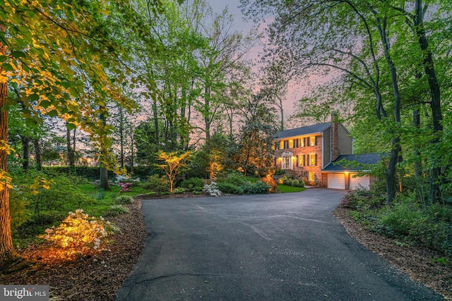 8412 Riverside Rd, Alexandria, VA 22308 - view of front of property with asphalt driveway, a chimney, and an attached garage