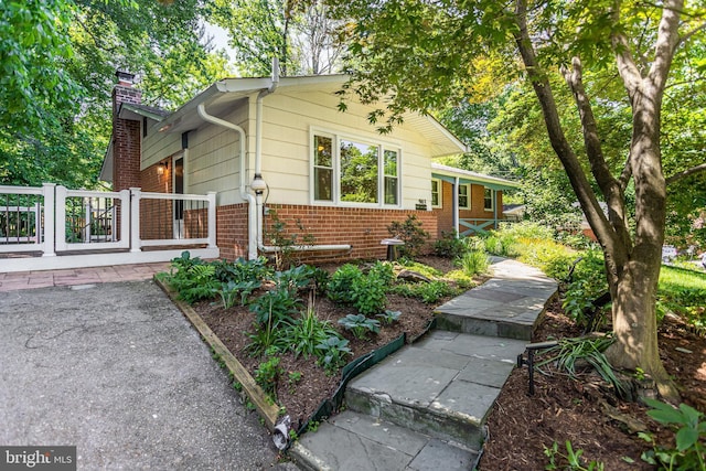 903 Burnt Crest Ln, Silver Spring, MD 20903 - view of front of house featuring a chimney and brick siding