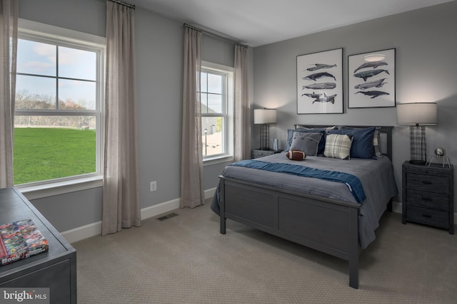 bedroom featuring carpet and baseboards