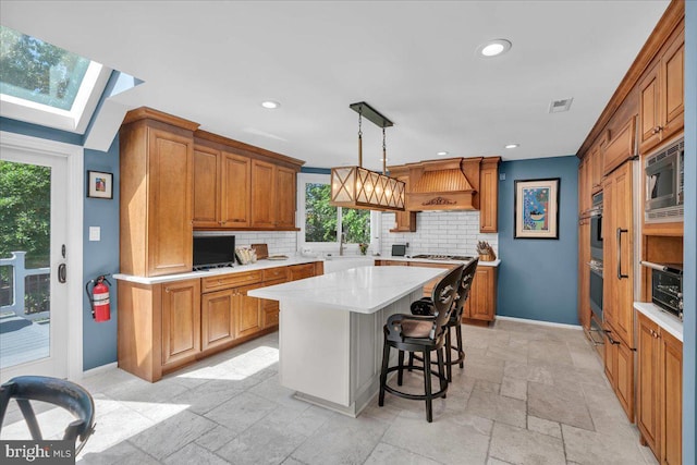 kitchen featuring appliances with stainless steel finishes, baseboards, backsplash, light countertops, and recessed lighting