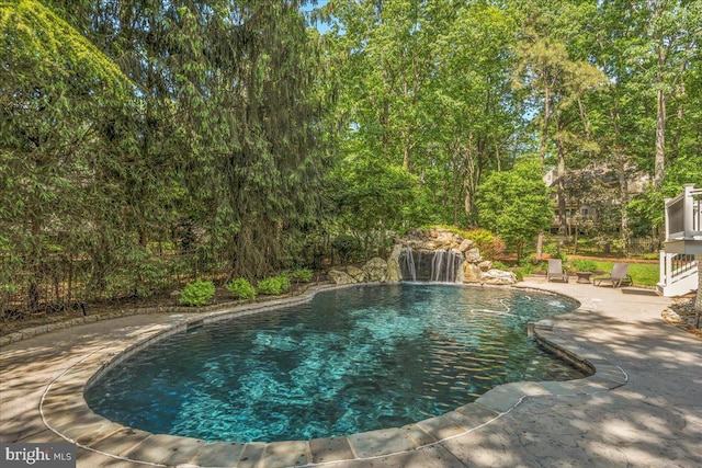 outdoor pool with a patio area