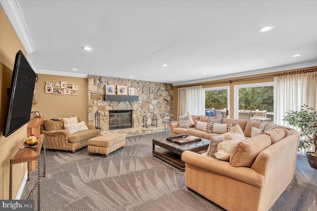 living room with ornamental molding, a stone fireplace, recessed lighting, and carpet flooring