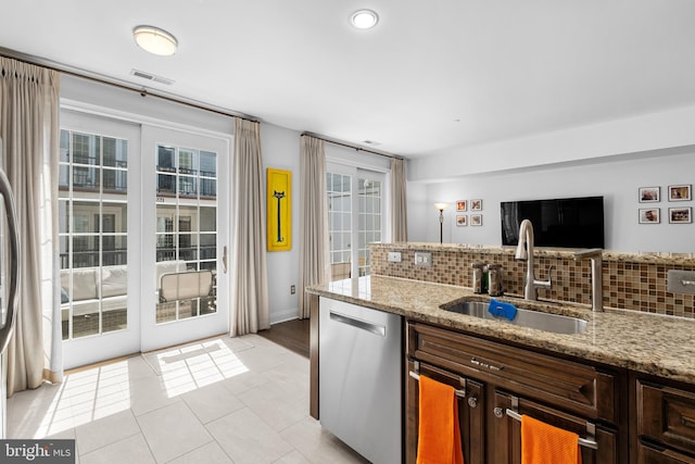 110 Commodore Ct, Philadelphia, PA 19146 - kitchen with stainless steel dishwasher, a sink, decorative backsplash, light stone countertops, and recessed lighting