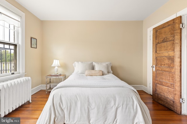 3650 Park Pl NW, Washington, DC 20010 - bedroom with radiator heating unit and wood finished floors
