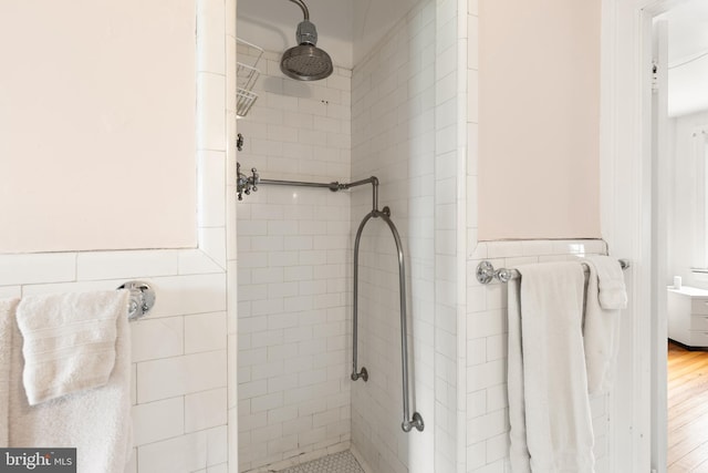 3650 Park Pl NW, Washington, DC 20010 - bathroom featuring a tile shower, tile walls, and wainscoting