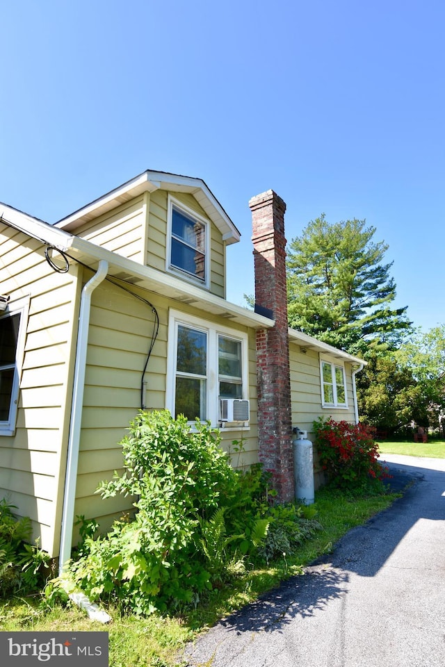 view of side of home featuring a chimney