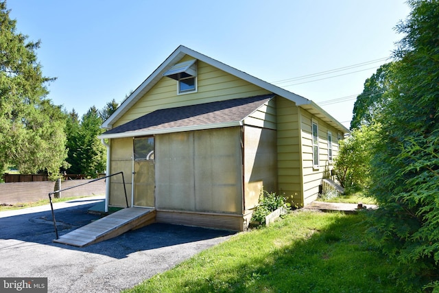 view of outbuilding featuring fence