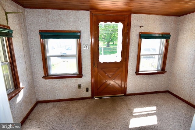 carpeted foyer entrance featuring wooden ceiling