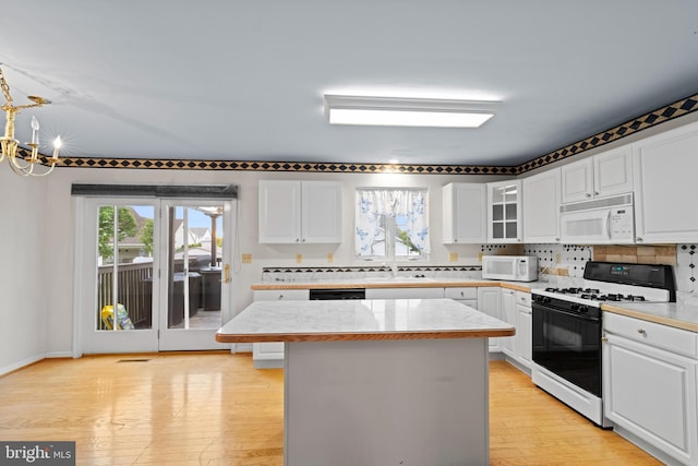 1004 Hostetter Rd, Hanover, PA 17331 - kitchen with white microwave, range with gas stovetop, light countertops, and a sink
