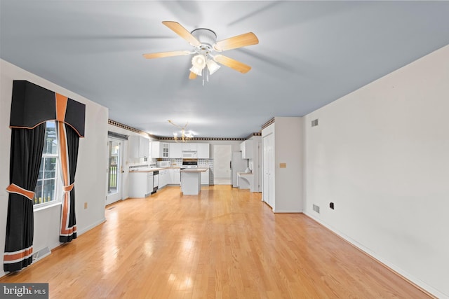 1004 Hostetter Rd, Hanover, PA 17331 - unfurnished living room with a chandelier, light wood-style floors, a ceiling fan, and baseboards