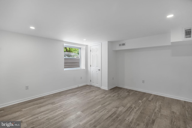 below grade area featuring wood finished floors, baseboards, and recessed lighting