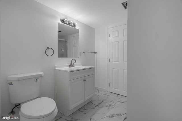 bathroom with marble look tile flooring, toilet, and vanity