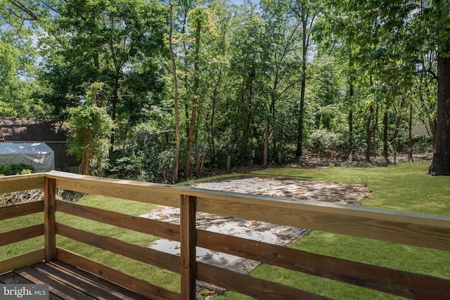 wooden terrace featuring a yard