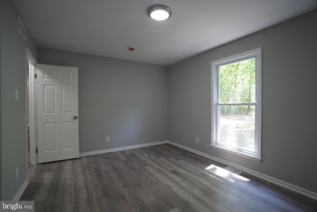 unfurnished room featuring wood finished floors and baseboards