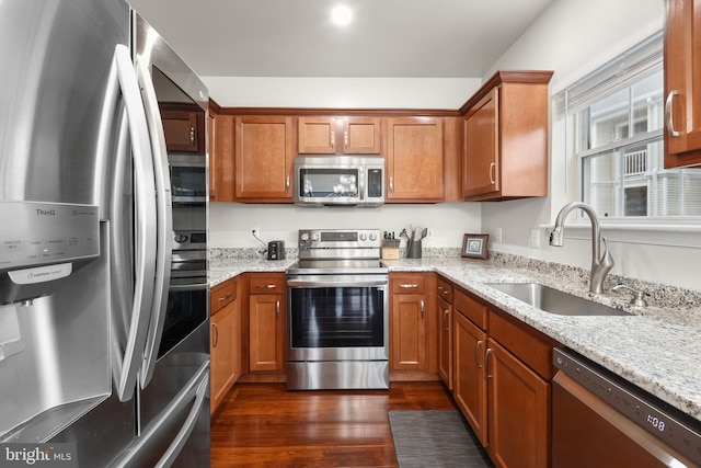4561 Strutfield Ln Unit 3218, Alexandria, VA 22311 - kitchen with stainless steel appliances, a sink, dark wood-style flooring, and brown cabinets
