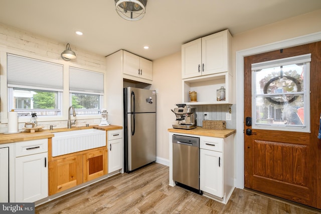282 Eaton Ave, Hamilton, NJ 08619 - kitchen featuring appliances with stainless steel finishes, wooden counters, a sink, light wood finished floors, and recessed lighting