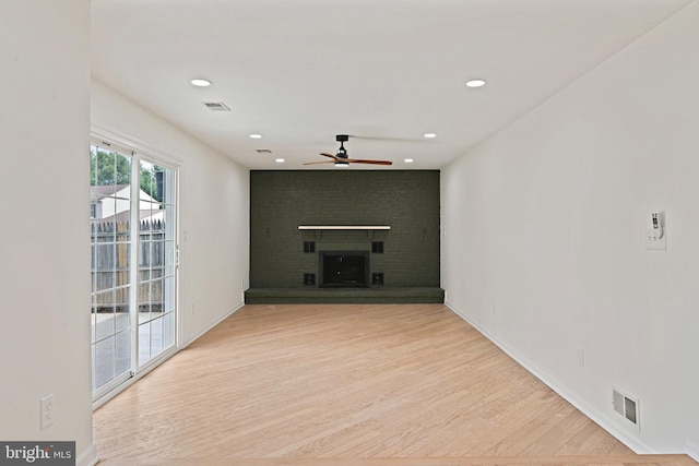 2144 Silentree Dr, Vienna, VA 22182 - unfurnished living room with a ceiling fan, a brick fireplace, wood finished floors, and recessed lighting