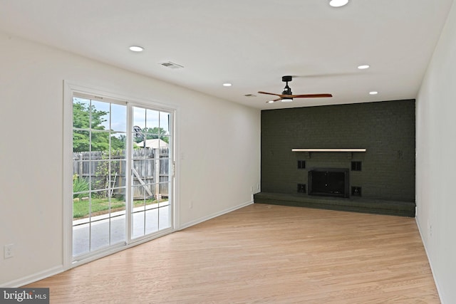 2144 Silentree Dr, Vienna, VA 22182 - unfurnished living room featuring ceiling fan, light wood finished floors, recessed lighting, and a brick fireplace