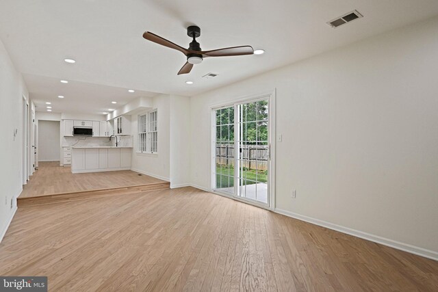 2144 Silentree Dr, Vienna, VA 22182 - unfurnished living room with a ceiling fan, light wood-style floors, and recessed lighting
