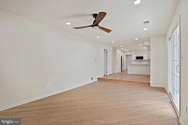 2144 Silentree Dr, Vienna, VA 22182 - unfurnished living room featuring light wood-type flooring, recessed lighting, ceiling fan, and plenty of natural light