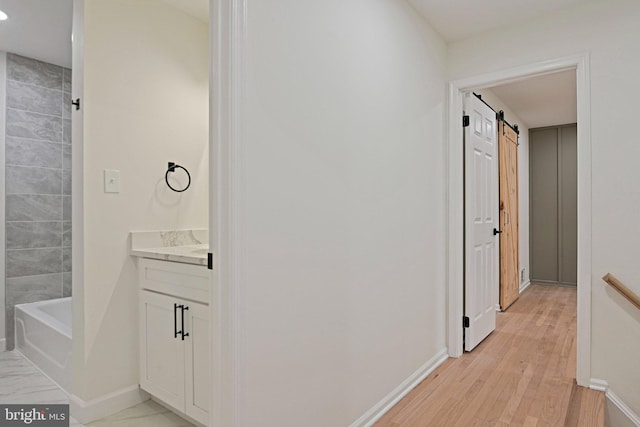 2144 Silentree Dr, Vienna, VA 22182 - hallway featuring a barn door, light wood finished floors, and recessed lighting