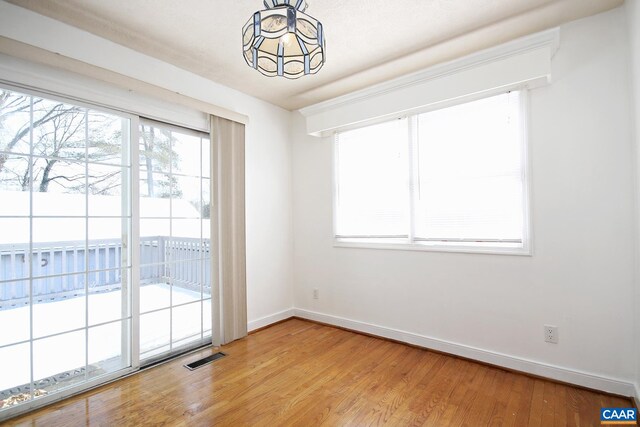 1024 Cottonwood Rd, Charlottesville, VA 22901 - spare room featuring wood finished floors, a chandelier, and baseboards