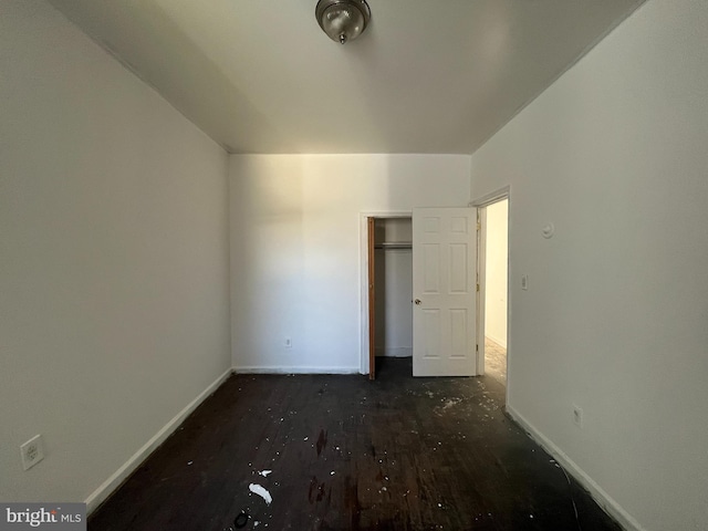 2742 W Mosher St, Baltimore, MD 21216 - unfurnished bedroom with baseboards, wood finished floors, and a closet