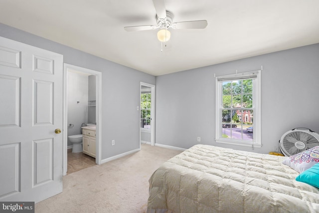 4439 Starling Ct, Woodbridge, VA 22193 - bedroom featuring multiple windows, light carpet, baseboards, and ensuite bath