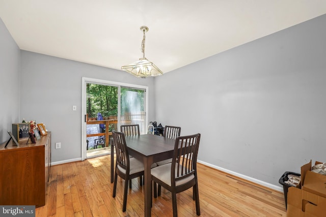 4439 Starling Ct, Woodbridge, VA 22193 - dining area featuring a chandelier, light wood-type flooring, and baseboards