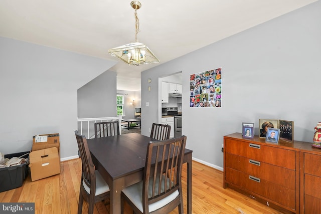 4439 Starling Ct, Woodbridge, VA 22193 - dining room featuring a chandelier, light wood-style floors, and baseboards