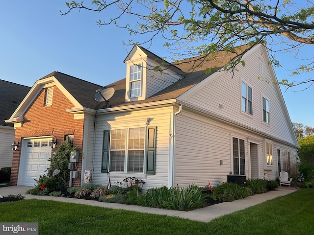view of property exterior featuring a garage and a yard