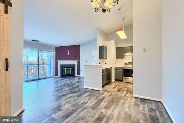 1210 Mist Wood Ct Unit 302, Belcamp, MD 21017 - kitchen with stainless steel appliances, under cabinet range hood, open floor plan, wood finished floors, and high vaulted ceiling