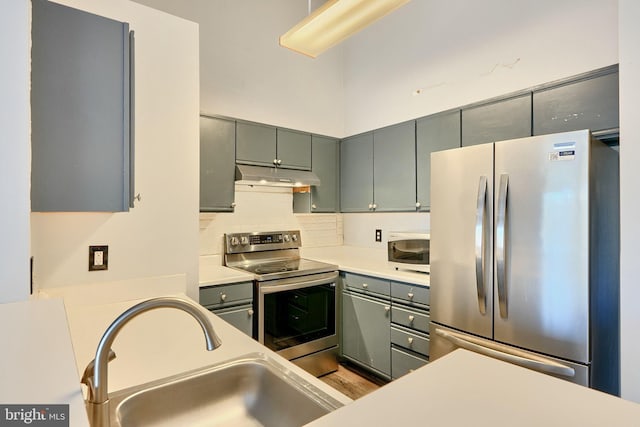 1210 Mist Wood Ct Unit 302, Belcamp, MD 21017 - kitchen featuring stainless steel appliances, under cabinet range hood, a sink, backsplash, and gray cabinets