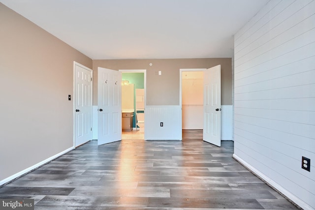 1210 Mist Wood Ct Unit 302, Belcamp, MD 21017 - unfurnished bedroom featuring wood finished floors, a closet, connected bathroom, and wooden walls