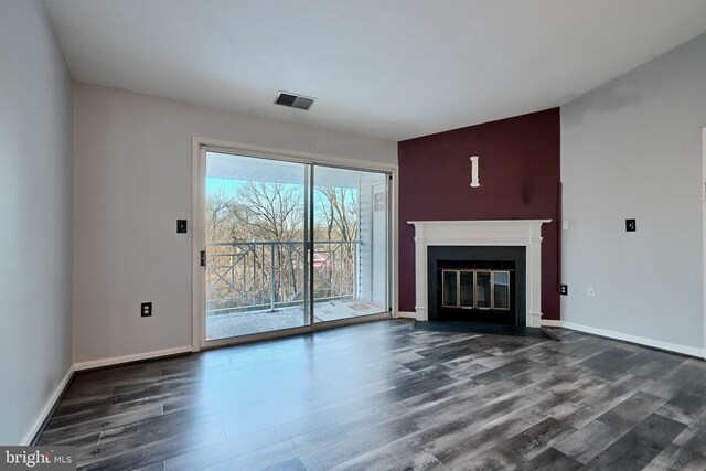 1210 Mist Wood Ct Unit 302, Belcamp, MD 21017 - unfurnished living room featuring dark wood-style floors, a fireplace with flush hearth, and baseboards