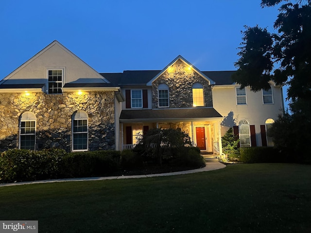 114 Saint Augustine Ct, Middletown, DE 19709 - traditional-style home featuring stone siding, a front lawn, and stucco siding