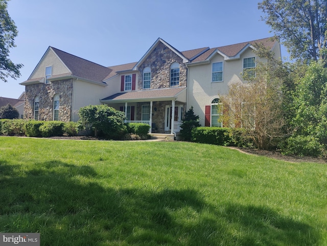 114 Saint Augustine Ct, Middletown, DE 19709 - traditional home featuring stone siding, a porch, and a front lawn
