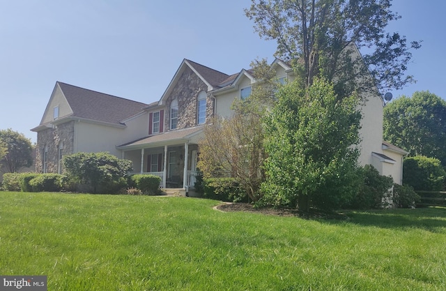 114 Saint Augustine Ct, Middletown, DE 19709 - view of side of property with stone siding, a yard, and stucco siding