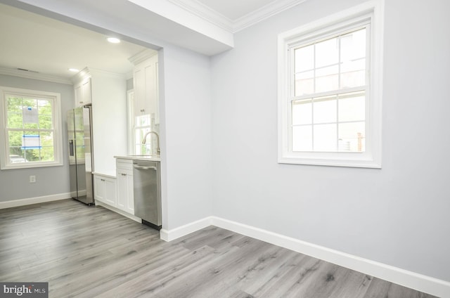 4915 78th Ave, Hyattsville, MD 20784 - empty room featuring baseboards, crown molding, light wood-type flooring, a sink, and recessed lighting