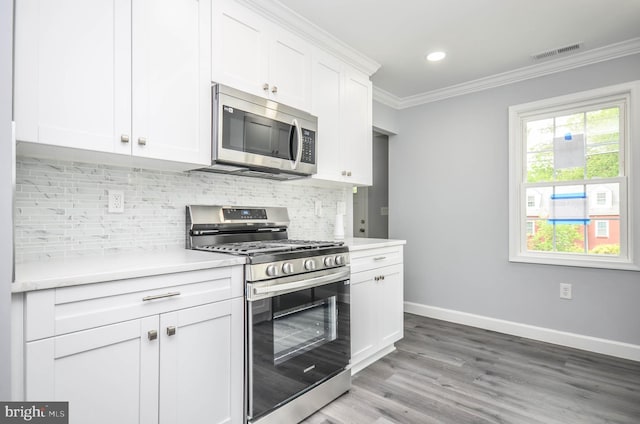 4915 78th Ave, Hyattsville, MD 20784 - kitchen with stainless steel appliances, ornamental molding, light countertops, baseboards, and tasteful backsplash