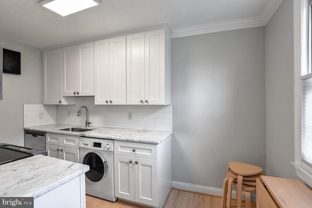 2625 3rd St NE Unit 105, Washington, DC 20002 - kitchen with washer / clothes dryer, a sink, tasteful backsplash, light wood-style floors, and ornamental molding
