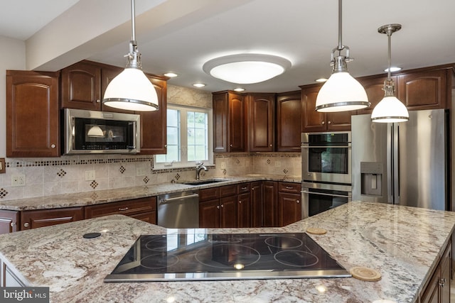 kitchen with stainless steel appliances, a sink, decorative backsplash, light stone counters, and pendant lighting