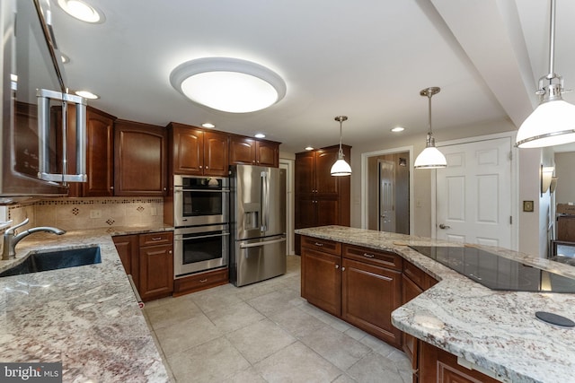 kitchen with stainless steel appliances, a sink, tasteful backsplash, light stone countertops, and recessed lighting