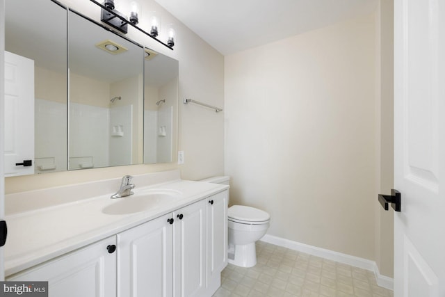 19355 Cypress Ridge Ter Unit 414, Leesburg, VA 20176 - bathroom with toilet, vanity, a shower, and baseboards
