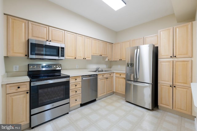 19355 Cypress Ridge Ter Unit 414, Leesburg, VA 20176 - kitchen with stainless steel appliances, light brown cabinetry, light flooring, light countertops, and a sink
