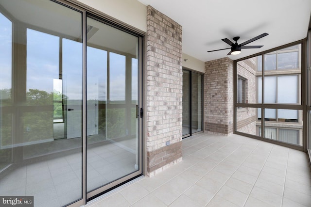 19355 Cypress Ridge Ter Unit 414, Leesburg, VA 20176 - unfurnished sunroom with ceiling fan, tile patterned flooring, floor to ceiling windows, and brick wall