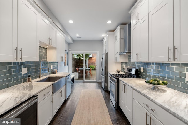 823 11th St NE, Washington, DC 20002 - kitchen with stainless steel appliances, wall chimney range hood, dark wood finished floors, a sink, and white cabinets
